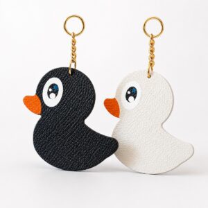 Black and white leather duck charms with gold hardware
